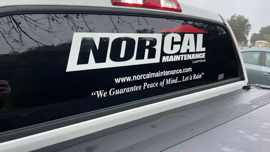Nor-Cal Maintenance pickup with the company logo, norcalmaintenance.com and the slogan "We Guarantee Peace of Mind... Let it Rain" on the rear window